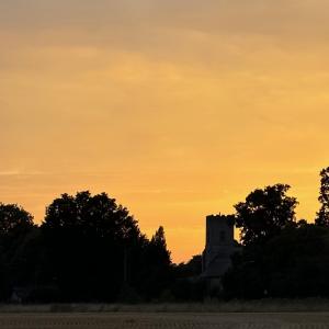 A golden sunset envelops the Church